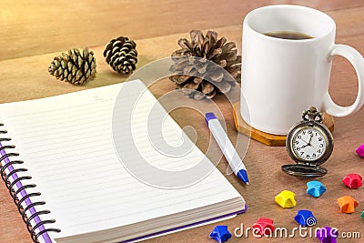 Black coffee with a notebook on a brown table. Stock Photo